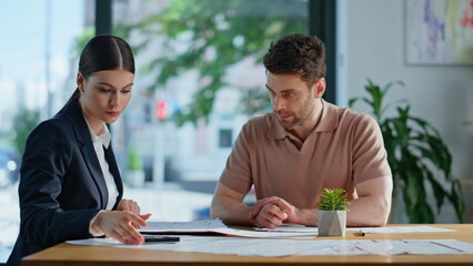 Business consultant calculating project to businessman at office meeting closeup