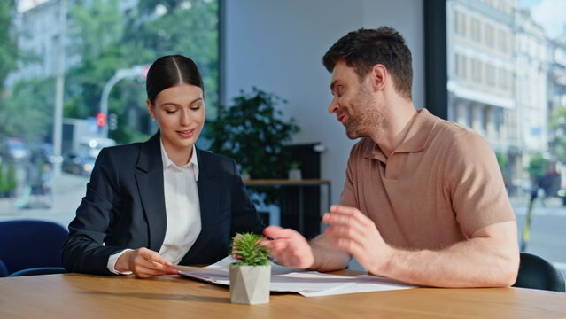 Business consultant explaining agreement details to investor at office closeup.