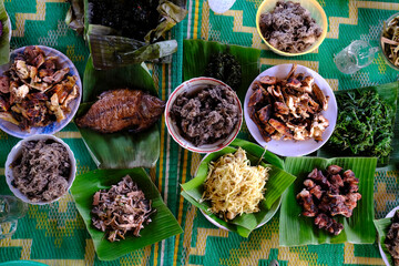 Traditional festive meal in a village on the highlands. Rice cooked over a wood fire in a bamboo pot. Kontum. Vietnam.