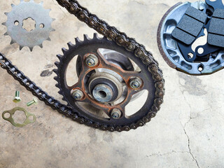Front, rear sprocket for motorcycle and front disc brake and rear drum brake motorcycle on cement...