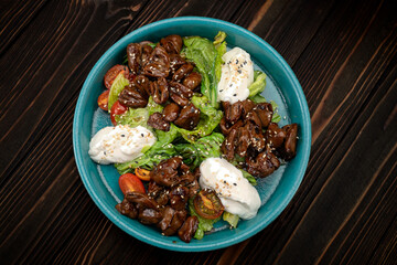 Appetizing warm salad with tender fried liver