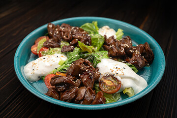 Appetizing warm salad with tender fried liver