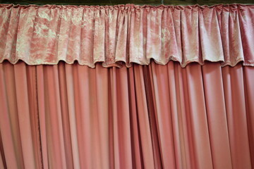 vergilbter ausgeblichener, roter Bühnenvorhang in Theaterbühne in Bauruine eines Theaters 