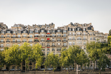 Classic Parisian Apartment Buildings with Green Trees under a Bright Sky