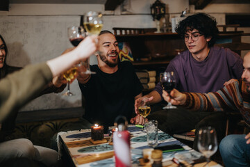 A group of friends celebrating and raising their glasses while sitting at a cozy table. The scene captures laughter, togetherness, and a warm atmosphere, perfect for gatherings and celebrations.