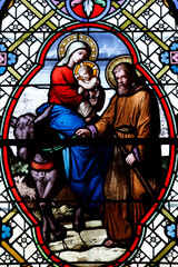 Saint-Pierre church.  Stained glass. The Flight into Egypt. Holy Family.. Chateau Chalon. France.