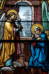 Fototapeta premium Saint Germain church. Stained glass. The Annunciation is the announcement by the angel Gabriel to the Virgin Mary that she will become the mother of Jesus. Saint-Germain du Bois. France.