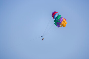 tourists parasailing on a sea seen against the clear blue sky