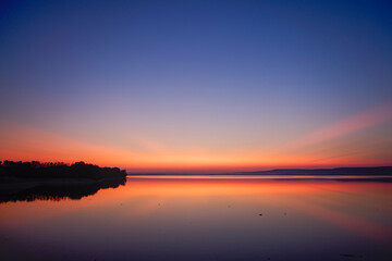 landscape with colorful sky over a lake a few minutes after sunset
