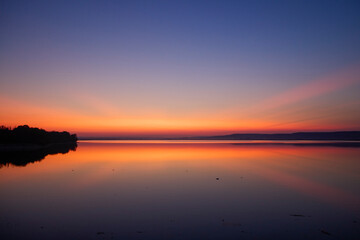 landscape with colorful sky over a lake a few minutes after sunset
