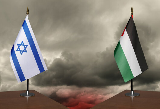 Table flags Israe and Palestine a stormy sky in the background