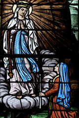 Obraz premium Saint Pierre church. Stained glass. Our Lady of Lourdes. Toucy. France.