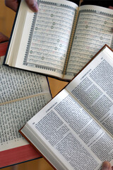 Three monotheistic religions. A Christian, a Jew, and a Muslim reading the Bible, the Torah, and the Quran. Symbol of peace and interfaith dialogue.