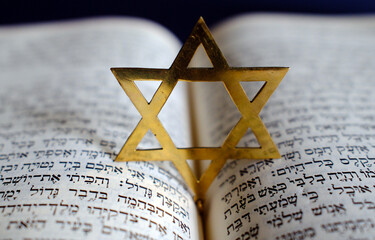 Fototapeta premium Judaism. The Bible in Hebrew with a star of David.