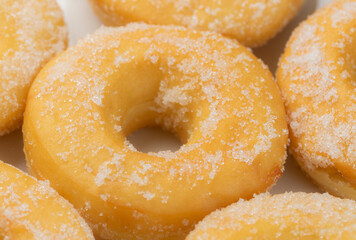 Sugar sprinkles donuts on white plate. Close-up
