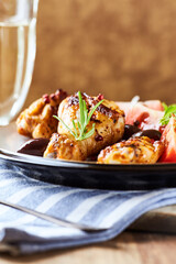 Grilled chicken pieces with fresh salad. Wooden background.	