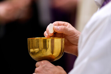 Catholic church. Sunday mass. Priest giving Holy Communion. Saint Pierre et Paul church.  Saint...