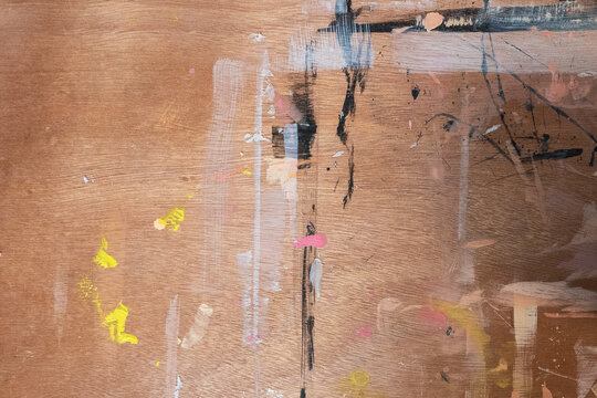 Art studio messy wooden desk texture with colourful paint splatters, artist painter's table background