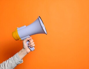 Hand Holding Bright Purple Megaphone Against Vibrant Orange Background for Announcements