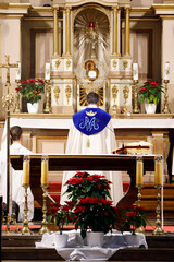 Eucharist (Blessed Sacrament) inside the Monstrance (Ostensory). Catholic priest  during Eucharistic adoration at church.  Church of the Holy Spirit.  Warsaw. Poland.