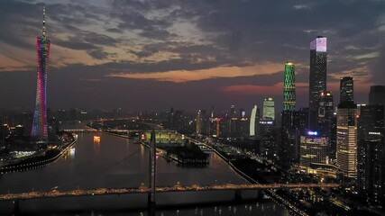 Evening traffic crosses guangzhou hunter bridge under a beautiful sunset sky with cantonese tower and illuminated city skyline - Powered by Adobe