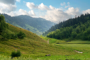 The valley of the Malaya Dukka River surrounded by the mountains of the North Caucasus and the tourist trail to the Dukka Lakes on a sunny summer day, Arkhyz, Karachay-Cherkessia, Russia © Ula Ulachka