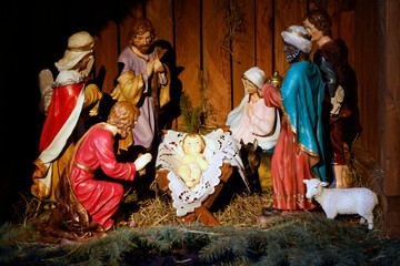 Nativity scene in a church. Nativity of Jesus or birth of Christ.  Adoration of the Child Jesus by...