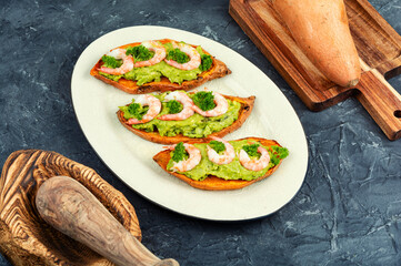Sweet potato or yam with avocado and shrimp.