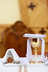 Catholic church. Sunday mass. Eucharist table with chalice and cruets. Mang Den Virgin Mary...