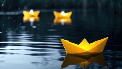 Yellow paper boats float gently on calm water at dusk, creating a serene and whimsical scene.