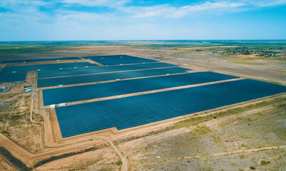 Solar energy farm located in a vast arid landscape generating renewable energy under clear blue skies