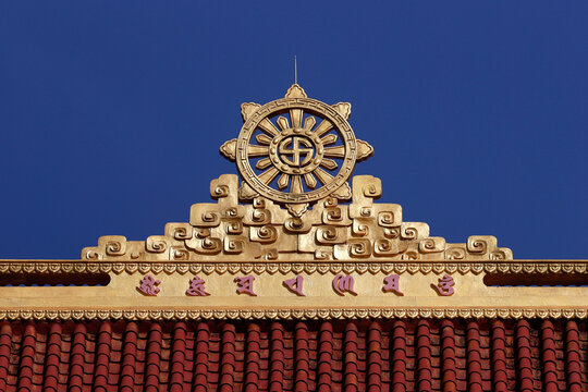 Buddhist temple. Tile roof. The dharma wheel, or dharmachakra in Sanskrit, is one of the oldest symbols of Buddhism.  Pleiku. France.