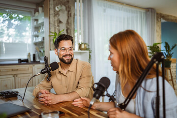 man and woman host and guest in podcast at home studio