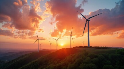 Obraz premium Wind turbines on hilltop under vibrant sunset sky
