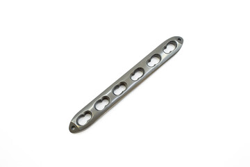 Sleek metal tibial plate with multiple holes for secure attachment and stability