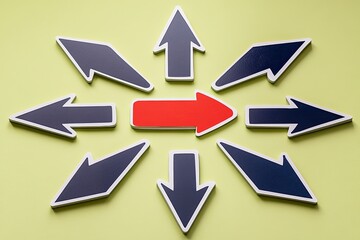 Multiple arrows pointing to a central red arrow