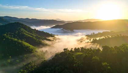 Mountainscape at Dawn: A breathtaking aerial panorama unfolds as the first light of dawn kisses the peaks and valleys, revealing layers of misty clouds nestled in the lush embrace of green hills.