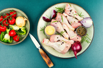 Raw chicken leg pieces with spices.