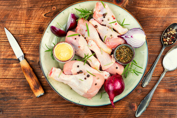 Group of raw chicken legs.
