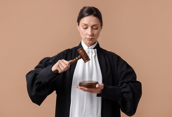 Judge with mallet and sound block on light brown background