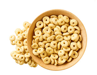 Whole grain cereal rings pouring out of wooden bowl isolated on white background. Top view.