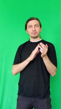 The man's exaggerated clapping and expressive facial gestures create a sarcastic or disingenuous mood. This shot is perfect for comedic skits, ironic reactions, or to subtly convey disdain
