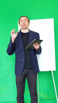 This footage conveys an informative and interactive mood, ideal for educational videos, business presentations, or explainer content where a dynamic speaker uses visual aids to convey information