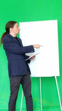 This footage conveys an informative and interactive mood, ideal for educational videos, business presentations, or explainer content where a dynamic speaker uses visual aids to convey information