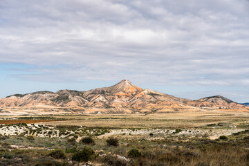 Bardenas reales natural park showcasing rock formations under cloudy sky in navarra, spain