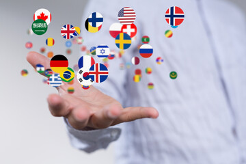 Image of diverse flags floating above a hand, symbolizing global reach and international collaboration.