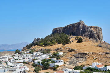 The white houses of Lindos at the foot of the historic castle on the top of a rock on the island of Rhodes