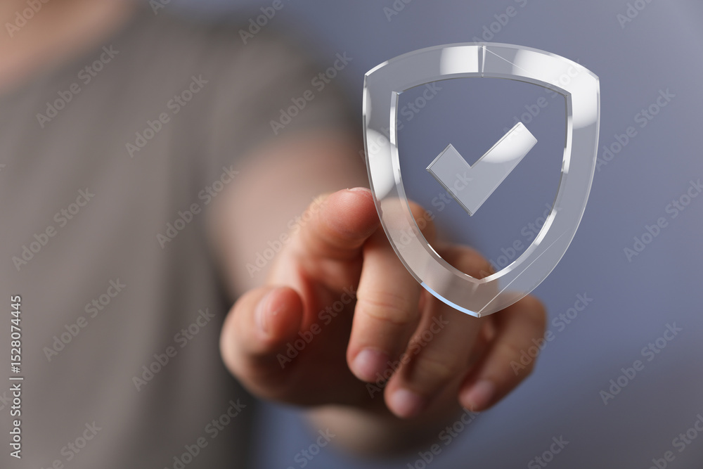 Poster hand pointing at a digital shield icon, symbolizing data protection and security.