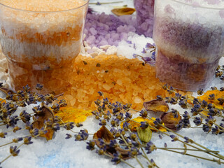Aromatic relaxing herbal and floral sea bath salt in the jars, various dried plants for making...