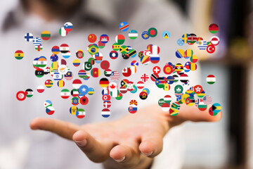 Image of a hand gently cradling numerous flags, symbolizing global unity and international...